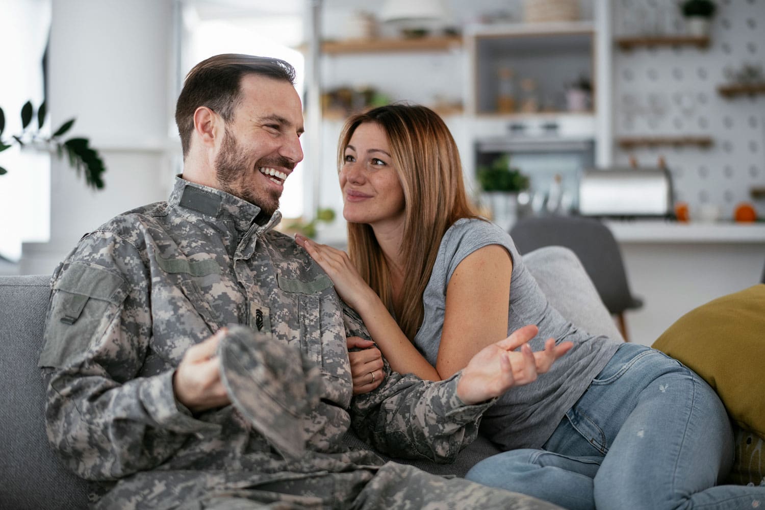 Featured image for Military Spouse Benefits, showing a male Servicemember and his wife on the couch