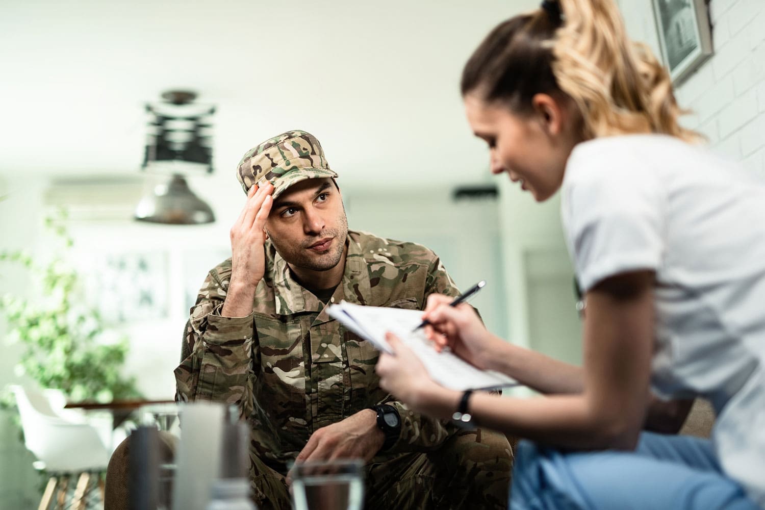 Featured image for Veteran Life Insurance, showing a male Veteran talking to a female doctor
