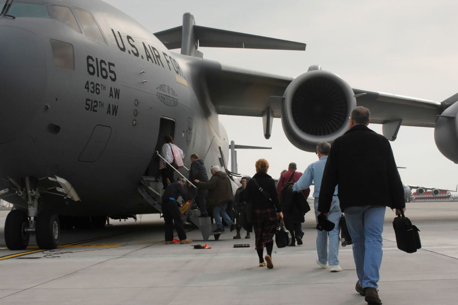 Featured image for Space-A Travel, showing military personnel, Veterans, and their families boarding a military Space-A flight