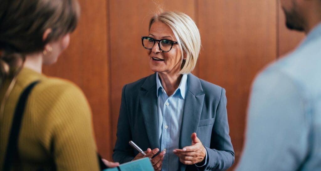 Image for Chapter 35 VA Benefits, showing a young adult and her father speaking with an academic advisor to choose the right school for her VA education dependent benefits.